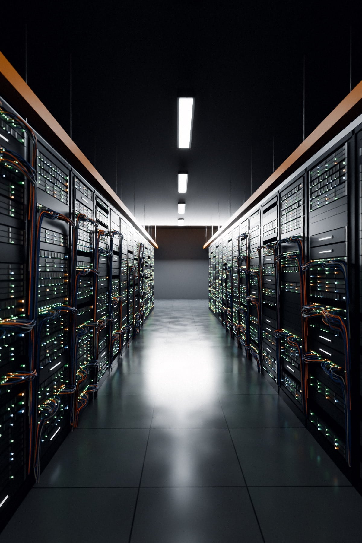 A data hall aisle with server racks on both sides, status lights on, under overhead strip lighting