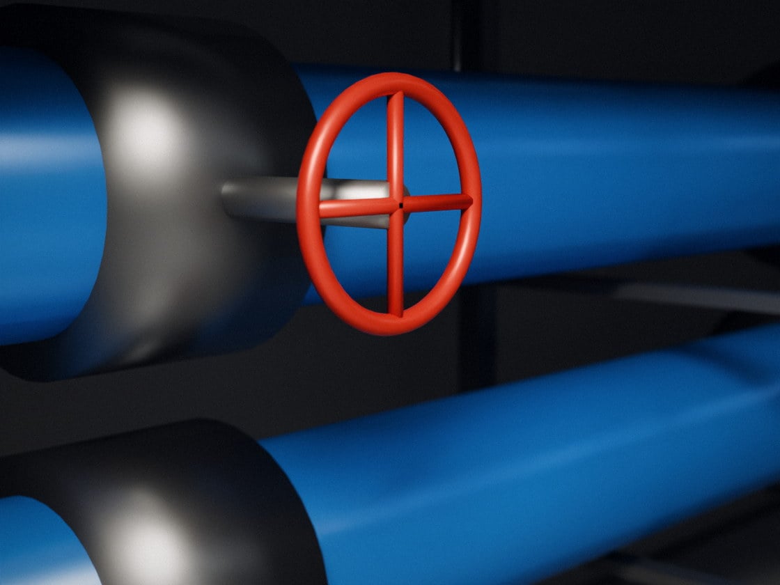 A red handwheel valve on blue chilled water pipes