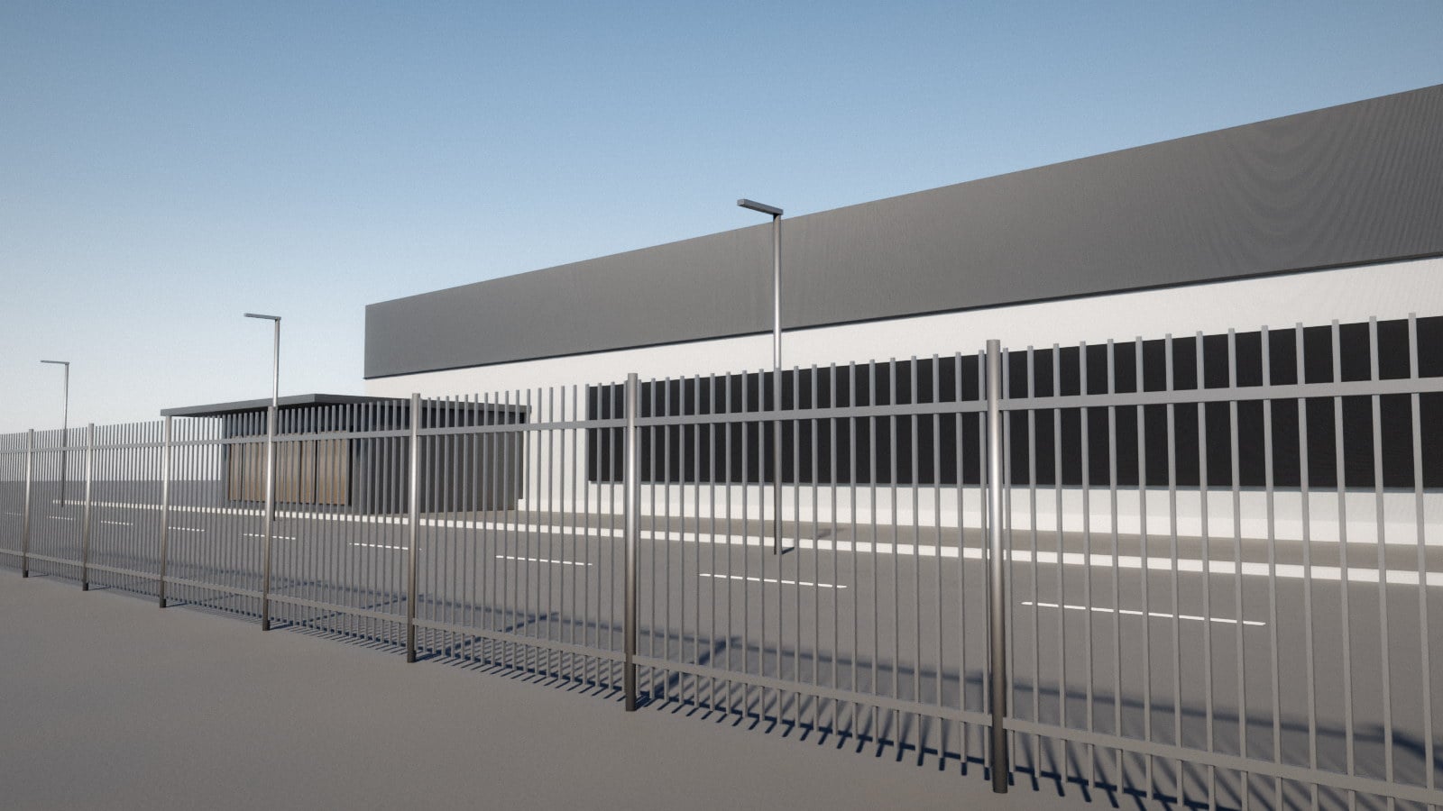 A windowless data centre building behind a perimeter fence, in daylight